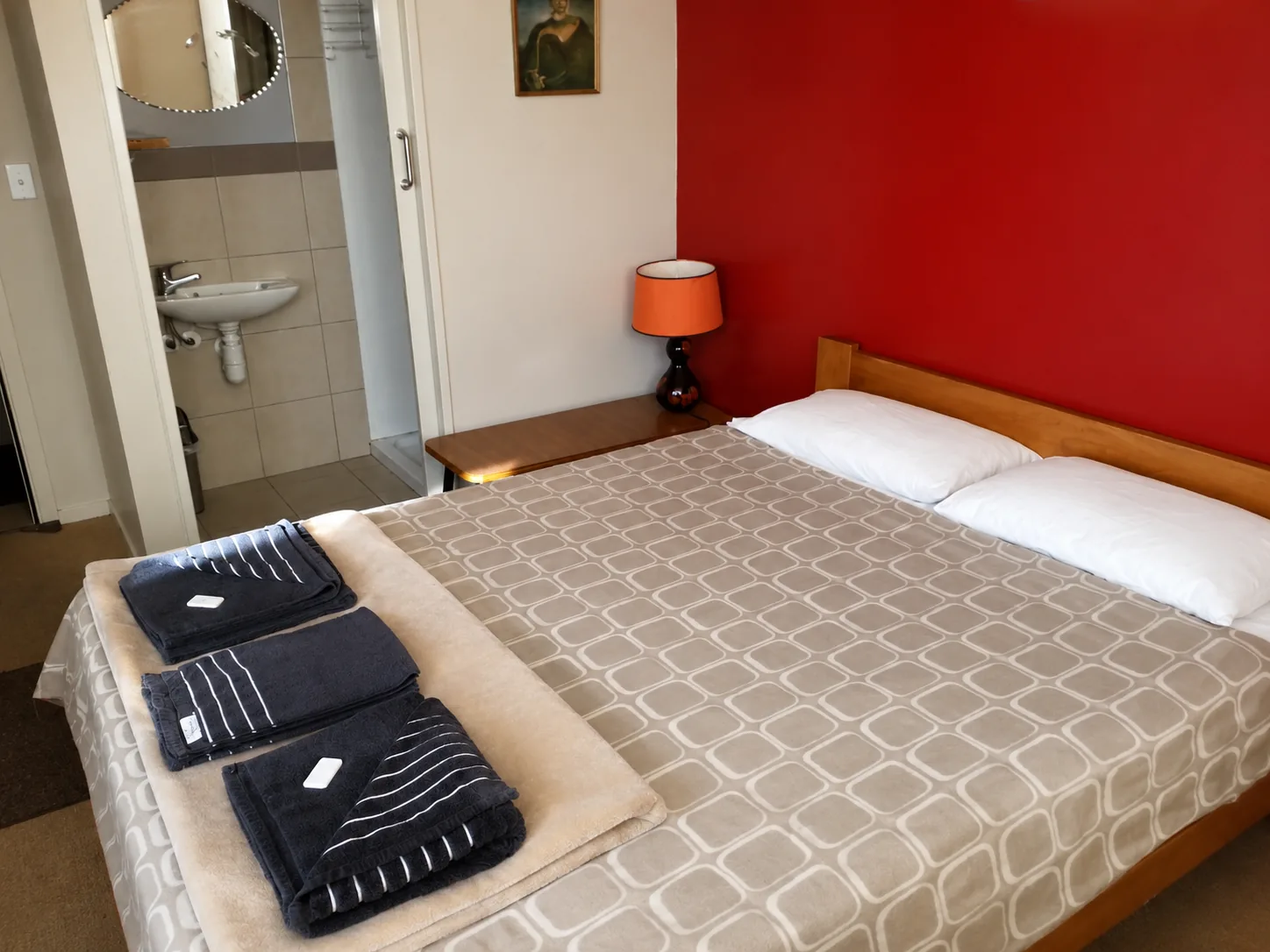 Private queen room with an ensuite bathroom and fresh towels laid out